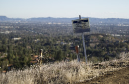 Warning signs line the Santa Susana Mountain range near Southern California Gas Company's fenced-off Aliso Canyon facility. A well at the site has been leaking methane since October. Photo: Scott L via Flickr