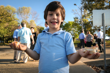 Sam Berman, 6, from the Temple Sinai in Pittsburgh, gets ready for the Tashlich ceremony held during Rosh Hashanah, the Jewish new year. During the service, bread is thrown in the river to symbolize the letting go of sins from the previous year. Photo: Lou Blouin