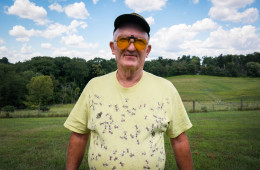 Terry Shanor, a beekeeper from Butler County, sports his favorite shirt at the annual picnic of the Pennsylvania State Beekepers Association. A co-op of beekeepers in the region are trying to breed tougher honeybees that can survive cold winters and fight back against parasitic mites. Photo: Lou Blouin