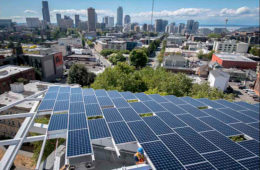 solar panels in the forefront of a city in the background