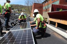 Solar installers on a building
