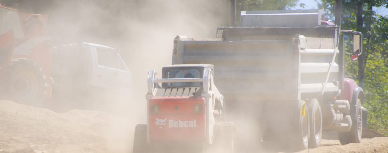 truck spreading liquid to suppress dust