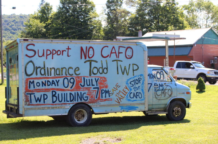 Truck with "No CAFO" sign.