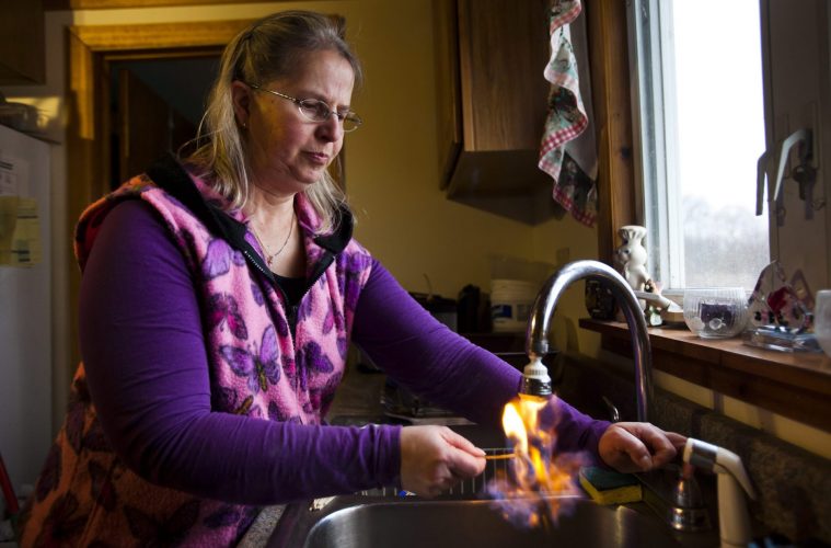 Woman lighting her water on fire