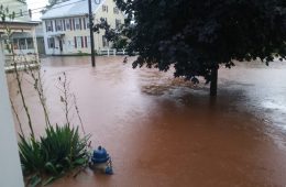 brown Floodwater on the streets near a home