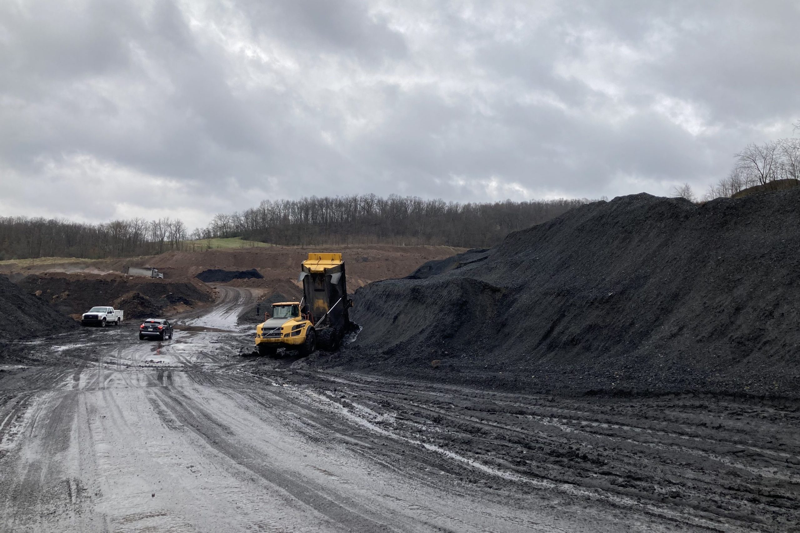 A dumptruck at a large pile of waste coal