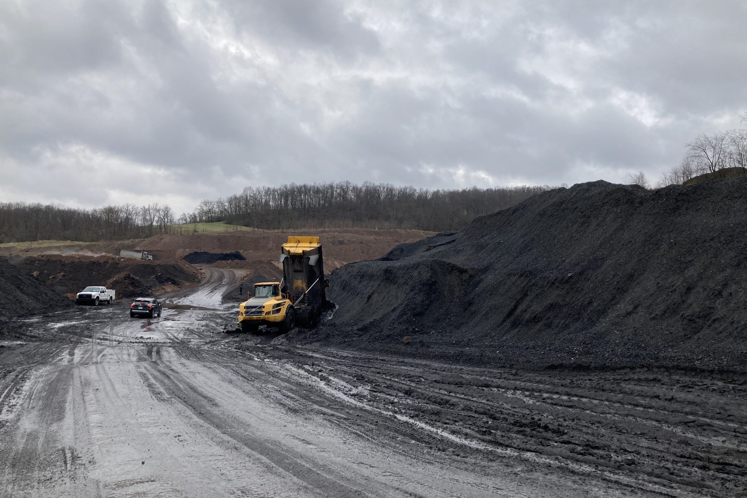 A dumptruck at a large pile of waste coal