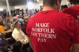 Man with a 'Make Norfolk Southern pay" t-shirt