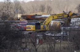 Construction equipment behind a fence