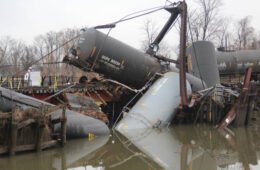 Wrecked train cars in a river