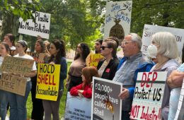 People at a rally holding signs