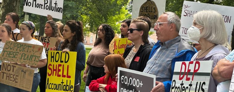 People at a rally holding signs