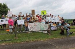 Activists holding signs gathered at Salt Fork State Park
