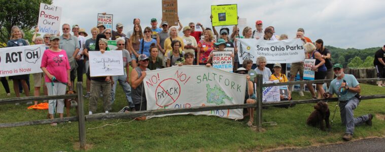 Activists holding signs gathered at Salt Fork State Park