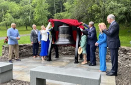 Group around an bronze bell