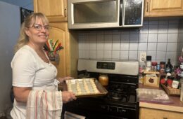 Krista King holding a tray of cookies in her kitchen