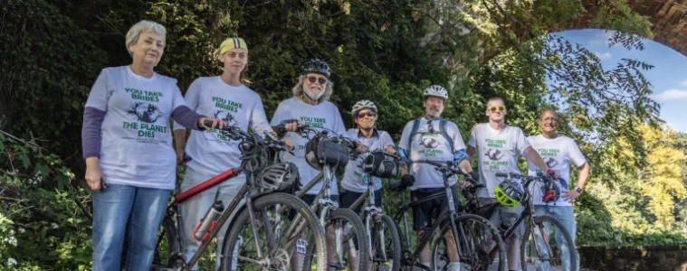 bike riders stand with their bikes