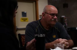 Mike Dugan sits at a table