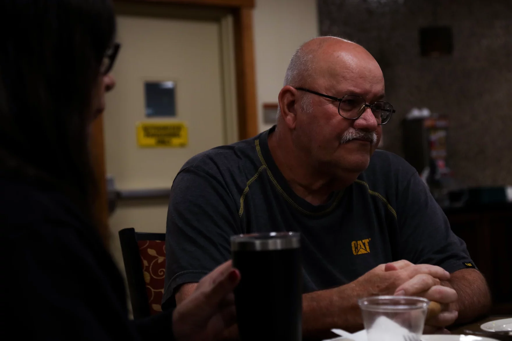 Mike Dugan sits at a table