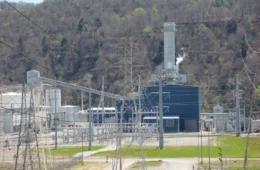 An industrial building behind transmission wires