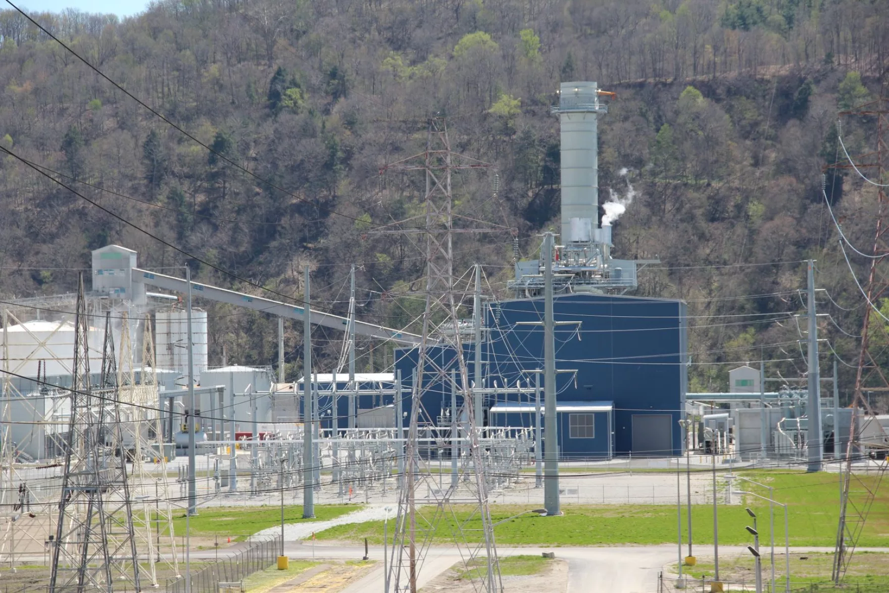 An industrial building behind transmission wires