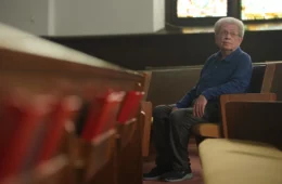 Bill Sutherin sits in a pew in the church