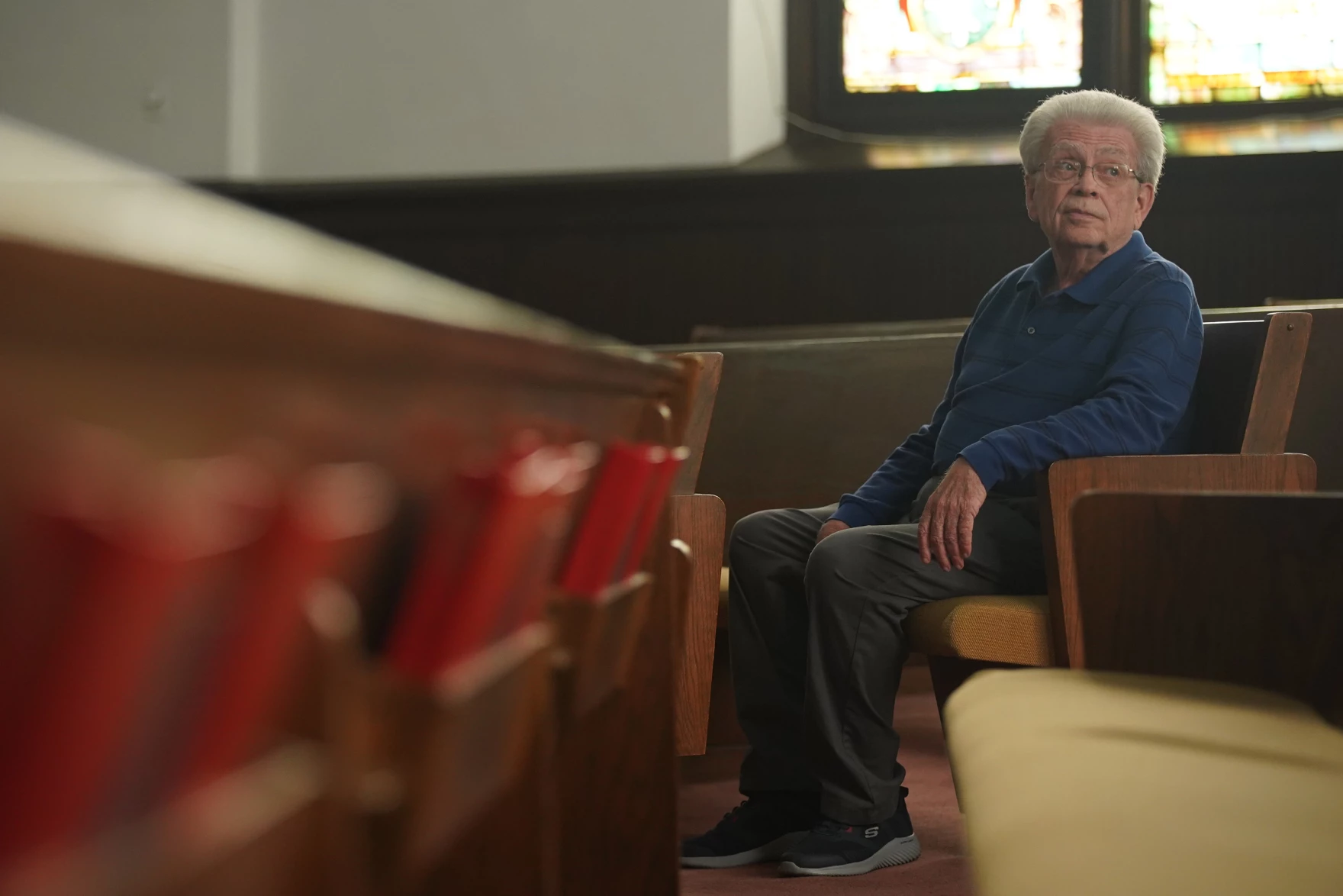 Bill Sutherin sits in a pew in the church