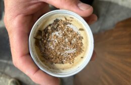 A close-up of a cup with brownish pellets