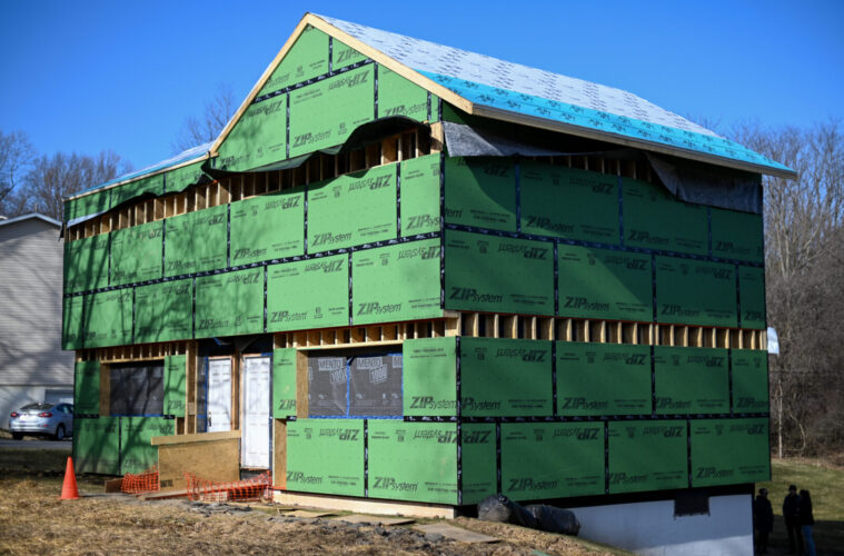 a house with green sheeting