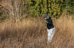 Josie Marsh stands in a field of tall yellow-brown grass