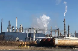 An industrial facility with smokestacks.