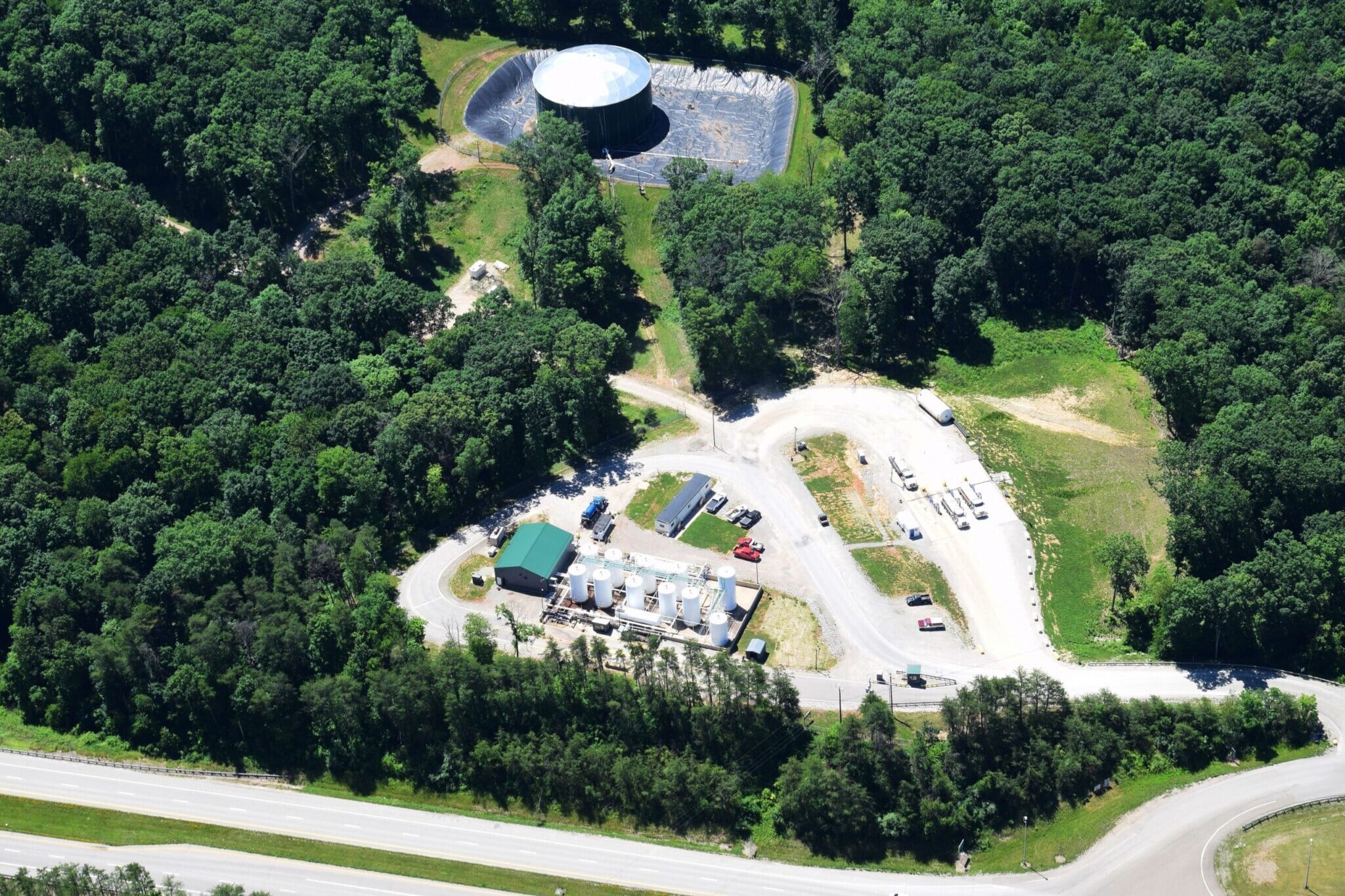 Drone photo of an industrial site in the midst of a wooded area