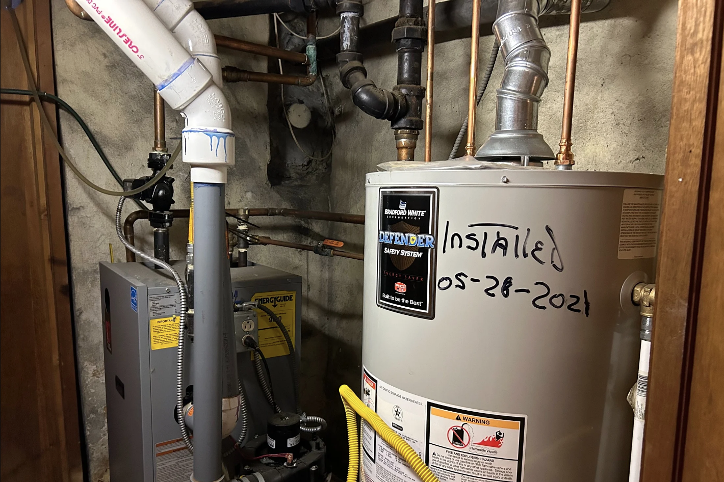 A gas-powered hot water tank in a basement
